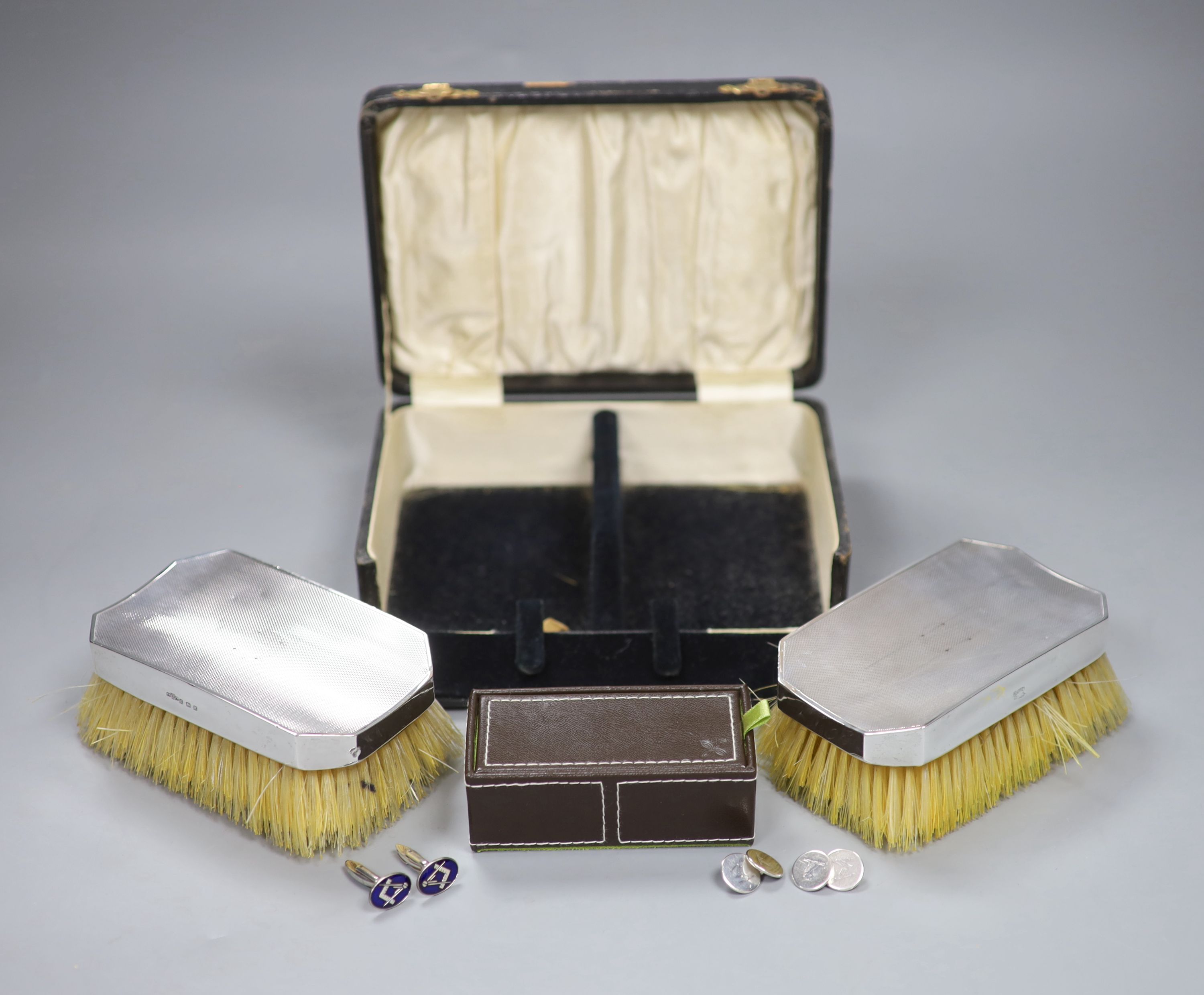 A pair of silver and enamel Masonic cufflinks, two other pairs and cased silver backed brushes.